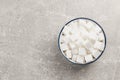 Bowl with sugar cubes on grey table, top view. Space for text Royalty Free Stock Photo