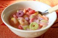 Bowl of sugary ring shaped cereal mixed with strawberry flavored yogurt Royalty Free Stock Photo