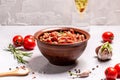 Bowl of sun dried tomatoes garlic, oregano, olive oil on a light background Royalty Free Stock Photo