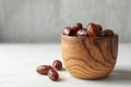 Bowl with sweet dates on table, space for text. Dried fruit