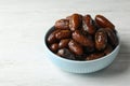 Bowl with sweet dates on wooden background Royalty Free Stock Photo