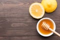 Bowl of sweet honey and lemons on wooden table Royalty Free Stock Photo