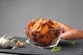 Bowl of sweet potato chips and garlic on table Royalty Free Stock Photo