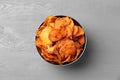 Bowl of sweet potato chips on grey table Royalty Free Stock Photo