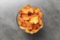 Bowl with sweet potato chips on grey table Royalty Free Stock Photo