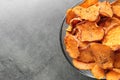 Bowl with sweet potato chips on grey table, top view. Royalty Free Stock Photo