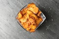 Bowl of sweet potato chips and salt on grey table Royalty Free Stock Photo