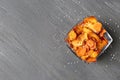 Bowl of sweet potato chips and salt on grey table, top view. Royalty Free Stock Photo