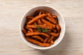 Bowl with sweet potato fries and rosemary on wooden table, top view Royalty Free Stock Photo