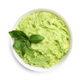 Bowl of tasty avocado sauce with basil on white background, top
