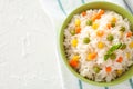 Bowl with tasty boiled rice and vegetables on white table Royalty Free Stock Photo