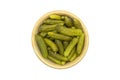 Bowl of tasty canned whole green cornichons isolated on a white background. Top view Royalty Free Stock Photo