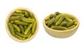 Bowl of tasty canned whole green cornichons isolated on a white background. Top view