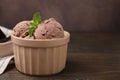 Bowl of tasty chocolate ice cream on wooden table, closeup. Space for text Royalty Free Stock Photo
