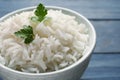 Bowl of tasty cooked rice with parsley on table Royalty Free Stock Photo