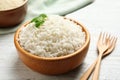 Bowl of tasty cooked rice on table