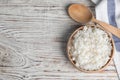 Bowl with tasty cooked rice on white table, flat lay. Space for text Royalty Free Stock Photo