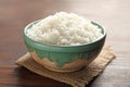 Bowl of tasty cooked white rice on wooden table Royalty Free Stock Photo