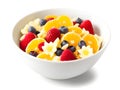 bowl of tasty cornflakes with berries on white background