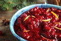 Bowl of tasty cranberry sauce with citrus zest on table Royalty Free Stock Photo