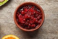 Bowl with tasty cranberry sauce on wooden background, top  view Royalty Free Stock Photo