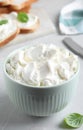 Bowl of tasty cream cheese on grey table Royalty Free Stock Photo