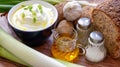 Bowl of tasty cream cheese with ingredients on a wooden table Royalty Free Stock Photo