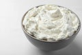 Bowl of tasty cream cheese on white table, closeup Royalty Free Stock Photo