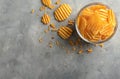 Bowl with tasty crispy potato chips on grey table Royalty Free Stock Photo