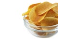 Bowl of tasty crispy potato chips on white background. Fast food snack Royalty Free Stock Photo