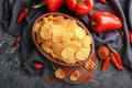 Bowl with tasty crispy potato chips on wooden board Royalty Free Stock Photo