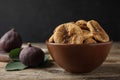 Bowl of tasty dried figs on wooden table