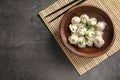 Bowl of tasty dumplings served on stone surface Royalty Free Stock Photo