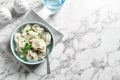 Bowl of tasty dumplings served on white marble table, top view Royalty Free Stock Photo