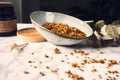 Bowl of tasty homemade Granola , cedar and leaves on the kitchen table