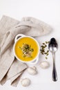 Bowl of Tasty Homemade Pumpkin and Mushrooms Soup with Cream and Pumpkin Seeds on Linen Napkin Raw Mushrooms and Pumpkin Seeds on Royalty Free Stock Photo