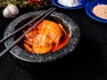 Bowl of tasty Kimchi - fermented Korean vegetables, and chopsticks