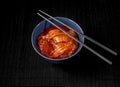 Bowl of tasty Kimchi - fermented Korean vegetables, and chopsticks