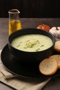 Bowl of tasty leek soup and bread on grey table, closeup Royalty Free Stock Photo