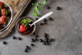 Bowl with tasty melted chocolate and ripe strawberry on grey table Royalty Free Stock Photo