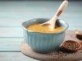 Bowl with tasty mustard soup on light blue wooden table, closeup. Made with Generative AI