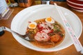 A bowl of tasty noodle with eggs, minced pork and red pork.