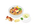 Bowl of tasty oat porridge decorated with fresh tropical fruits