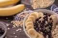 Bowl with tasty oatmeal, sliced banana and fresh berries on wooden table Royalty Free Stock Photo