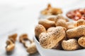 Bowl with tasty peanuts on table, closeup