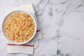 Bowl with tasty sauerkraut on white marble table, top view. Space for text Royalty Free Stock Photo