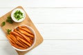 Bowl with tasty sweet potato fries and sauce on wooden background, top view Royalty Free Stock Photo