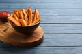 Bowl with tasty sweet potato fries on wooden background Royalty Free Stock Photo