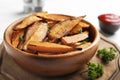 Bowl with tasty sweet potato fries on wooden board Royalty Free Stock Photo