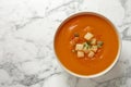 Bowl of tasty sweet potato soup on marble table, top view Royalty Free Stock Photo